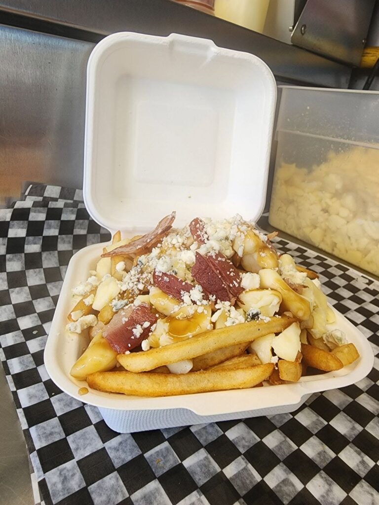 Loaded poutine with bacon and melted cheese from Smashed YXY